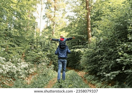 Similar – Hiker woman with backpack raising her arms into the forest