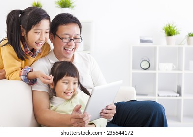 happy father using tablet pc with little girls - Powered by Shutterstock