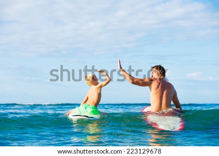 Happy Father and Young Son Going Surfing Together