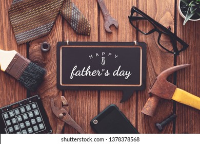 Happy father's day background concept. Flat lay of construction  handy tools and  gentleman's accessories over wooden background with black chalkboard and Happy father's day text. - Powered by Shutterstock