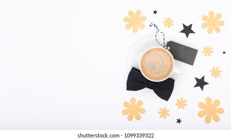 Happy Father's Day Background. Cup of coffee and black bow tie on white background flat lay. Floral Fathers day still life setup. - Powered by Shutterstock