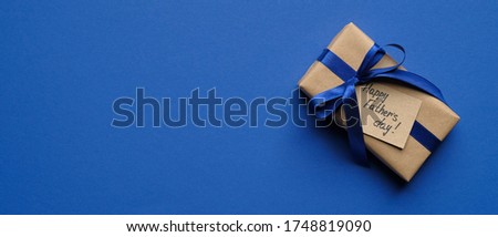 Happy Fathers Day banner template. Top view vintage gift box with label Happy Father's Day on blue background with copy space.