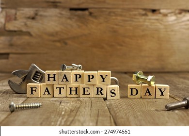 Happy Fathers Day Blocks With Tools On A Rustic Wood Background