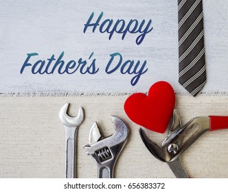 Happy Father's day card concept, Pliers with red heart and necktie on white wood table background - Powered by Shutterstock