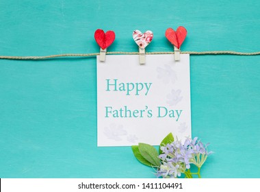 Happy Father's day card idea, greeting card with heart clip and flower on blue texture background - Shutterstock ID 1411104491