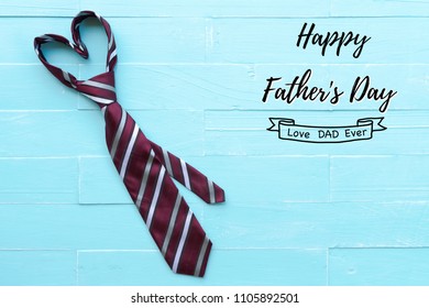 Happy fathers day concept. Red tie in heart shape on bright blue pastel wooden table background. - Powered by Shutterstock