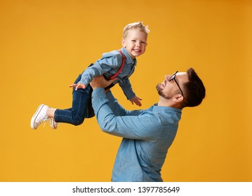 happy father's day! cute dad and son hugging on colored yellow background
 - Powered by Shutterstock