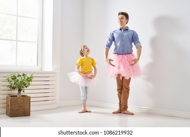 Happy Father's Day! Dad And His Daughter Child Girl Are Playing, Smiling And Dancing. Family Holiday And Togetherness.