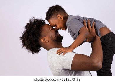 Happy Fathers Day! father holding his son on gray background with free space for text