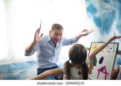 Happy Father's day  Funny portrait smiling father   her daughter painting   drawing and watercolor Easel happily at her home 