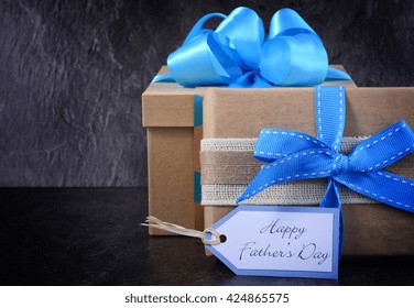 Happy Fathers Day Gift On Black Slate Background.