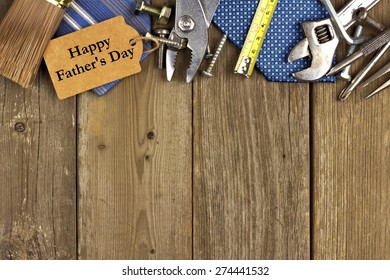 Happy Fathers Day gift tag with top border of tools and ties on a rustic wood background