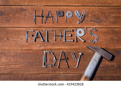 Happy Father's Day. Greeting card made of metallic bolts and iron nails - Powered by Shutterstock