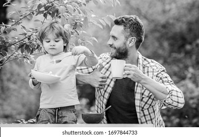 happy fathers day. Little boy with dad eat cereal. son and father eating outdoor. Morning breakfast. Family bonds. Enjoying time together. healthy food and dieting. Having a healthy breakfast. - Powered by Shutterstock