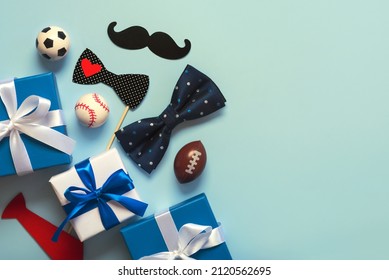 Happy Father's Day. Top view of gifts boxes ,false bow tie and sports balls with copy space. Father's Day celebration concept over blue background. Father's Day celebration concept

 - Powered by Shutterstock