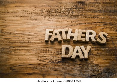 Happy Fathers Day wooden letters on a rustic wood background. empty space - Powered by Shutterstock