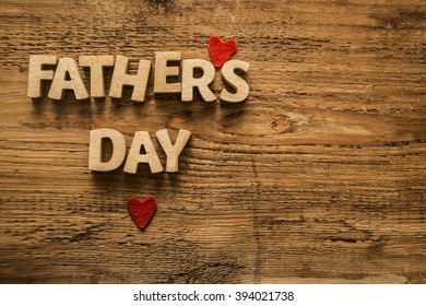 Happy Fathers Day wooden letters on a rustic wood background. empty space for inscription or objects. two red heart - Powered by Shutterstock