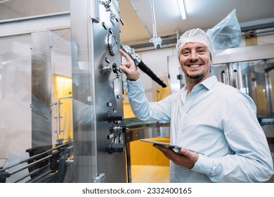 happy fatory engineer technician machine operate config setting working in food and drink factory - Powered by Shutterstock