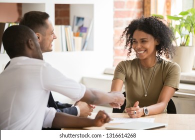 Happy female african vacancy candidate shaking hand of hr recruiting manager congratulating hired applicant with handshake, successful interview winner make good first impression got new job concept - Shutterstock ID 1316614268