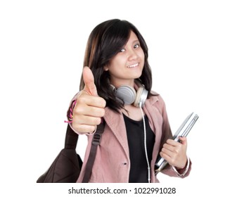 Happy Female Asian Middle Schooler Showing Her Thumb Up To Camera, Isolated Over White