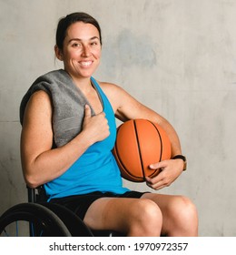 Happy Female Athlete In A Wheelchair With A Basketball