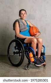 Happy Female Athlete In A Wheelchair With A Basketball