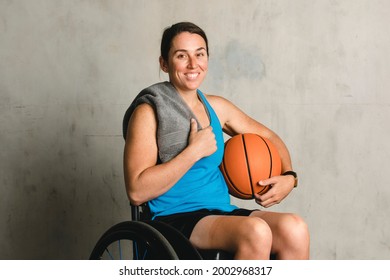 Happy Female Athlete In A Wheelchair With A Basketball