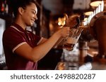 Happy female bartender pouring beer draft beer while working in a pub.