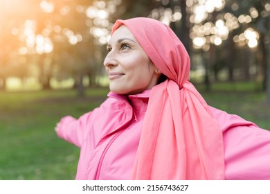 happy female breast cancer survivor looking positively to the sky after overcoming disease. fighter concept with pink bandana - Shutterstock ID 2156743627