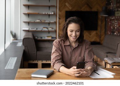 Happy Female Business Leader, Entrepreneur, Business Woman Using Financial App Or Service Smartphone At Home, Office Workplace, Reading Text On Screen, Chatting Online, Shopping, Making Call, Smiling