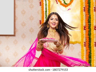 Happy Female Celebrating Diwali. Carrying Pooja Thali in hand  - Shutterstock ID 1807279153