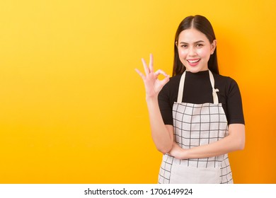 Happy Female Cook Portrait On Yellow Background 