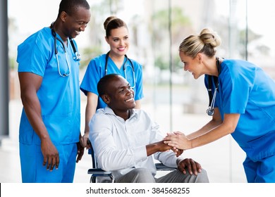 happy female doctor greeting disabled patient in hospital - Powered by Shutterstock