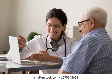 Happy female doctor and senior male patient look at computer screen consider good results after treatment or therapy. Smiling woman GP consult man client using laptop. Modern medical service concept. - Powered by Shutterstock