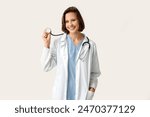 Happy female doctor with stethoscope on white background