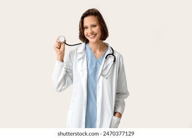 Happy female doctor with stethoscope on white background - Powered by Shutterstock