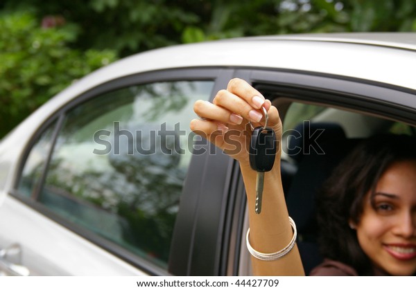 happy female driver\
showing car keys