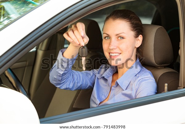 Happy female driver showing\
car key
