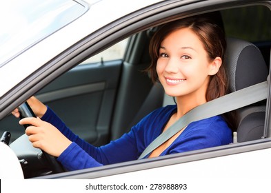 Happy female driver smiling to you