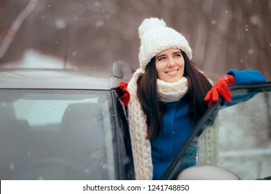 Happy Female Driver Standing By Her Car Admiring The Snow. Smiling Girl Next To Her Vehicle Relaxing In Winter Journey Trip
