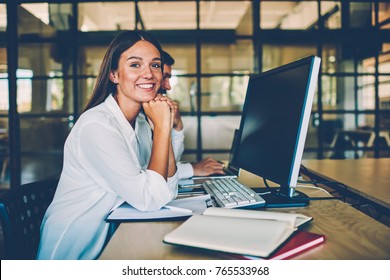 Happy Female Employee Resting During Work Break Looking At Camera Enjoying Time In Office, Portrait Of Brunette Cheerful Woman Satisfied With Occupation Collaborating With Male Colleague For Project