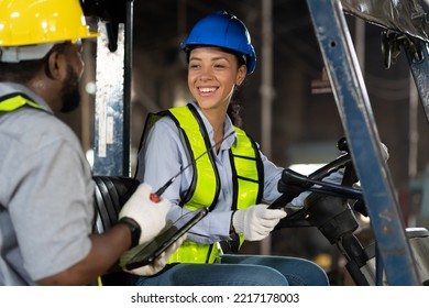 Happy female engineer driving and operating on forklift truck in the industry factory. Woman technician wear safety helmet, glasses and uniform working and driving forklift truck - Shutterstock ID 2217178003