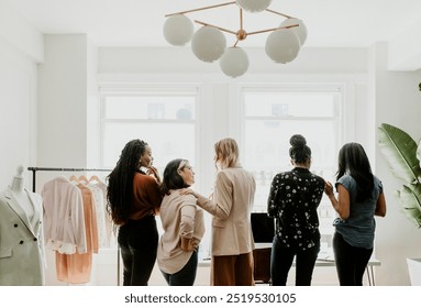 Happy female fashion designers working together, team of women working together in studio, women small business fashion, business meeting and brainstorm, businesswomen doing small business - Powered by Shutterstock