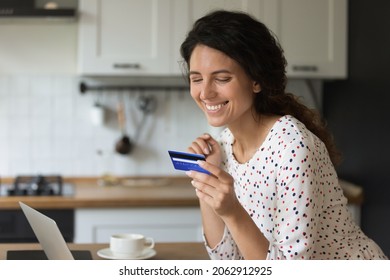 Happy female freelancer, entrepreneur using credit card with low servicing cost, good limit and cashback. Customer shopping online, paying for purchase, using bank payment service on laptop