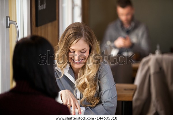 Happy Female Friends Having Coffee Together Stock Photo Edit Now