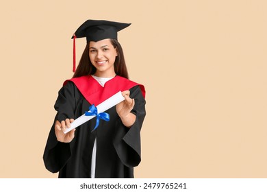 Happy female graduating student with diploma on beige background - Powered by Shutterstock