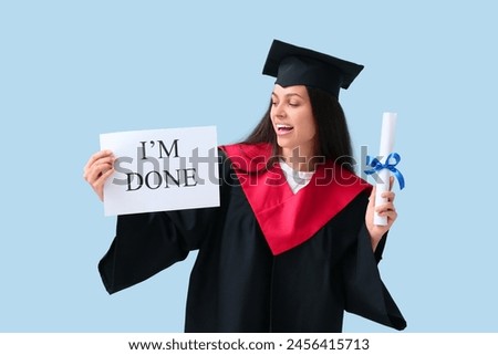Happy female graduating student holding diploma and paper sheet with text I'M DONE on blue background