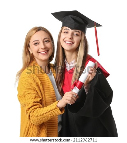 Happy female graduation student with her mother on white background