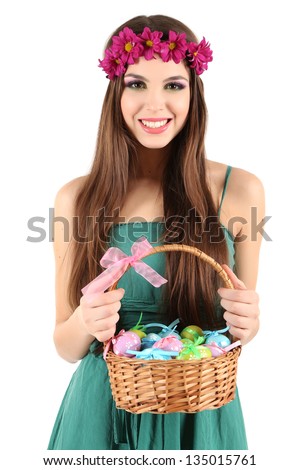 Happy female holding basket with Easter eggs, isolated on white