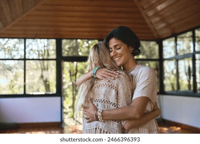 Happy female holistic coach hugging young woman during spiritual practice feeling gratitude and love, giving psychological help support during body health retreat healing recovery training session. - Powered by Shutterstock